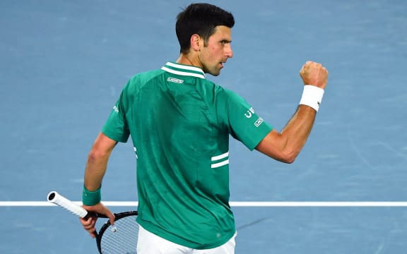 Serbia's Novak Djokovic reacts as he plays against France's Jeremy Chardy during their men's singles match on day one of the Australian Open tennis tournament in Melbourne on February 8, 2021.