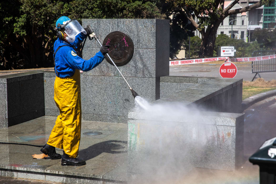Water blasting removes graffiti left on Parliament grounds by anti-mandate protesters.