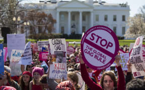 Women gather outside the White House on International Women's Day