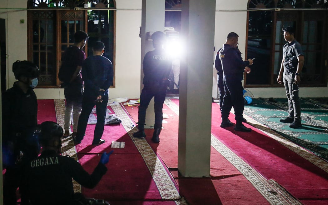 Police officials carry out an on-site investigation following a blast at a mosque inside a school in Jakarta on 7 November, 2025.