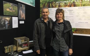 Kevin and Karen Bain with the automatically resetting rat trap.