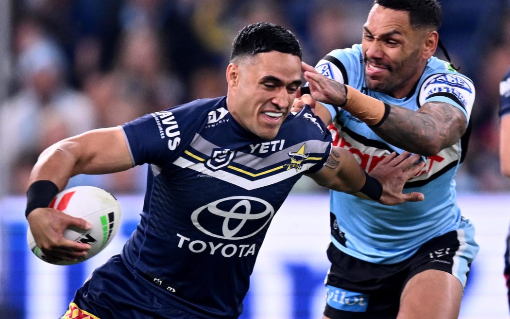 Valentine Holmes of the Cowboys is tackled by Sione Katoa of the Sharks.