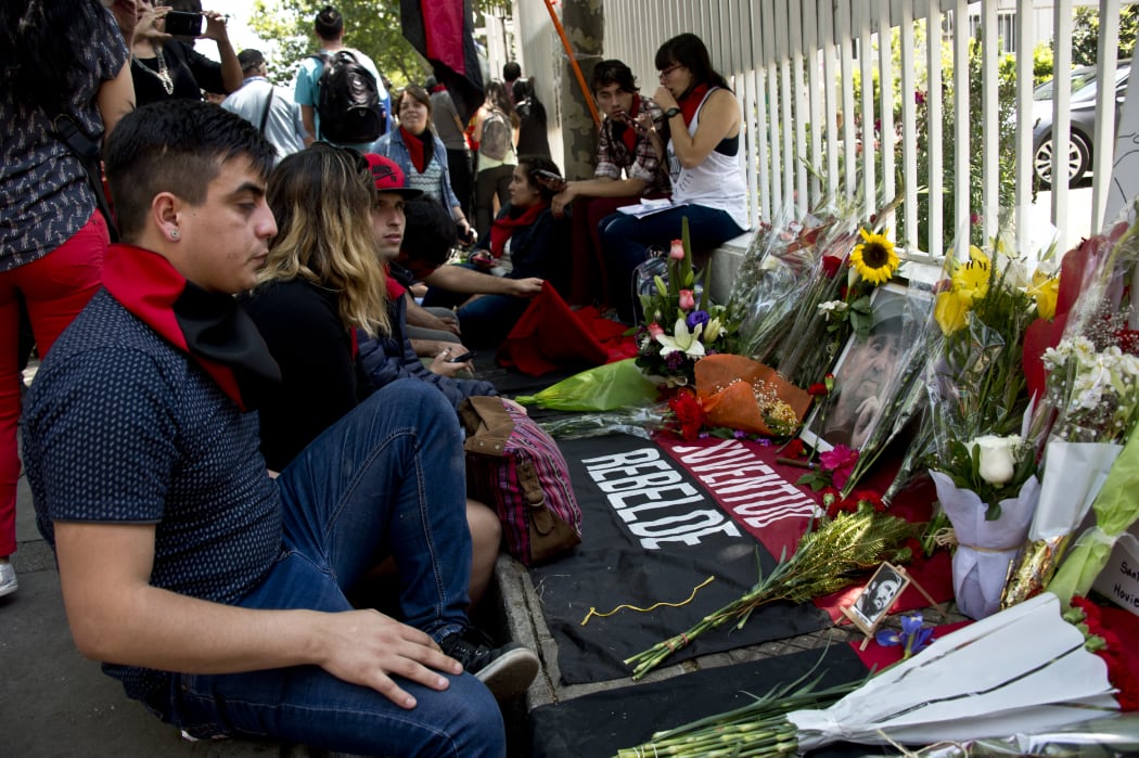 People gather to pay respects outside the Cuban embassy in Santiago, Chile, after Fidel Castro's death.