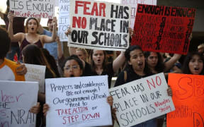 People join together after a school shooting that killed 17 to protest against guns on the steps of the Broward County Federal courthouse.