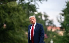 US President Donald Trump walks on the South Lawn of the White House after arriving on Marine One in Washington, DC, US, on Sunday, 13 July.