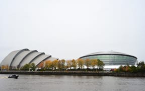 A police boat patrols on the River Clyde past the COP26 venue in Glasgow on October 31, 2021 ahead of the start of the climate summit