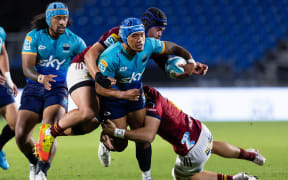 Moana Pasifika midfield back Danny Toala is tackled against the Highlanders in Auckland