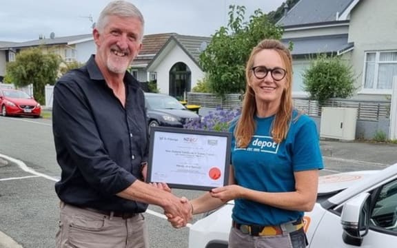Wendy Ramsay receives her qualification as floor and wall tiler from BCITO training advisor Stuart Caulfield.