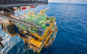 Drilling rig working on oil and gas wellhead platform