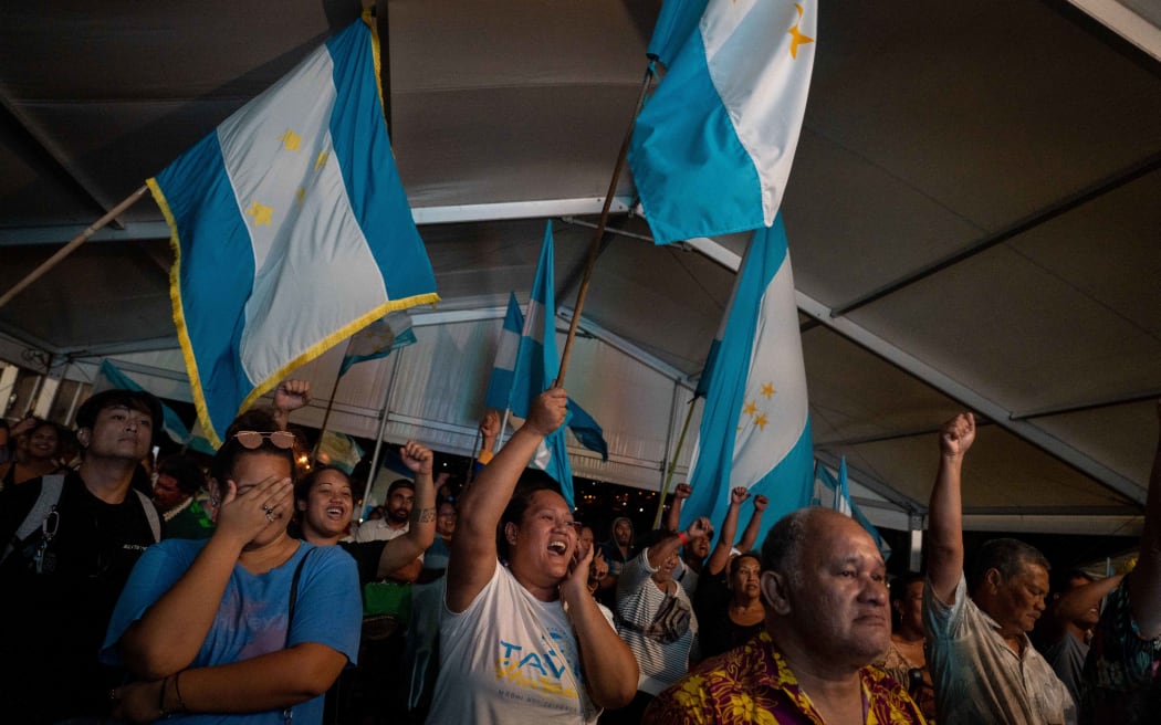 Pro-independence Tavini party supporters cheer after their victory following the second round of the territorial elections, at party headquarters in Faa'a.