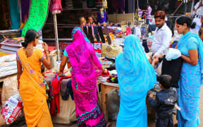 Women browsing a market stall in Agra city, Uttar Pradesh, India