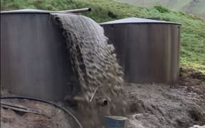 A screenshot of a video taken by Waikato Regional Council staff on 2 August 2023 shows effluent overflowing from a holding tank into a stream north of Te Aroha.