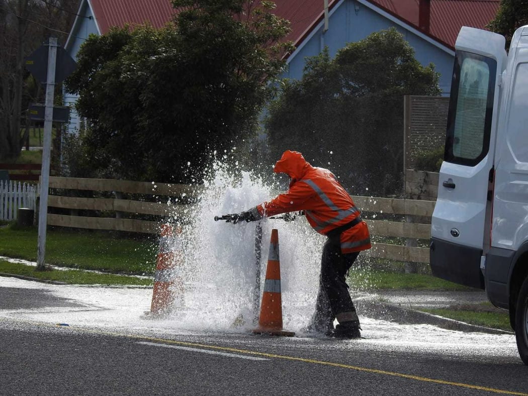 A contractor tries to tame a leak in Carterton.
