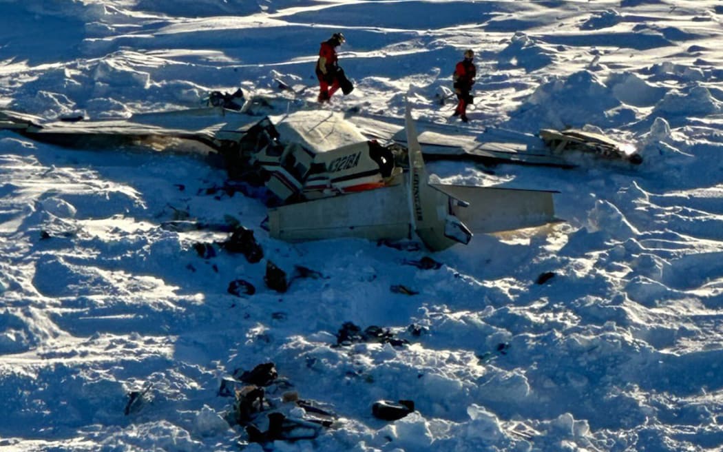 This image obtained from the US Coast Guard (USCG) on February 7, 2025, shows the remains of a plane reported missing February 6. The Bering Air Caravan was carrying nine passengers and one pilot on board. The search ended after the aircraft was located some 34 miles (55kms) southeast of Nome, Alaska. The USCG reported the three individuals were found inside and were deceased. "The remaining 7 people are believed to be inside the aircraft but are currently inaccessible due to the condition of the plane," according to a statement posted on the X of the USCG. (Photo by Handout / US Coast Guard / AFP) / RESTRICTED TO EDITORIAL USE - MANDATORY CREDIT "AFP PHOTO / US COAST GUARD" - NO MARKETING NO ADVERTISING CAMPAIGNS - DISTRIBUTED AS A SERVICE TO CLIENTS