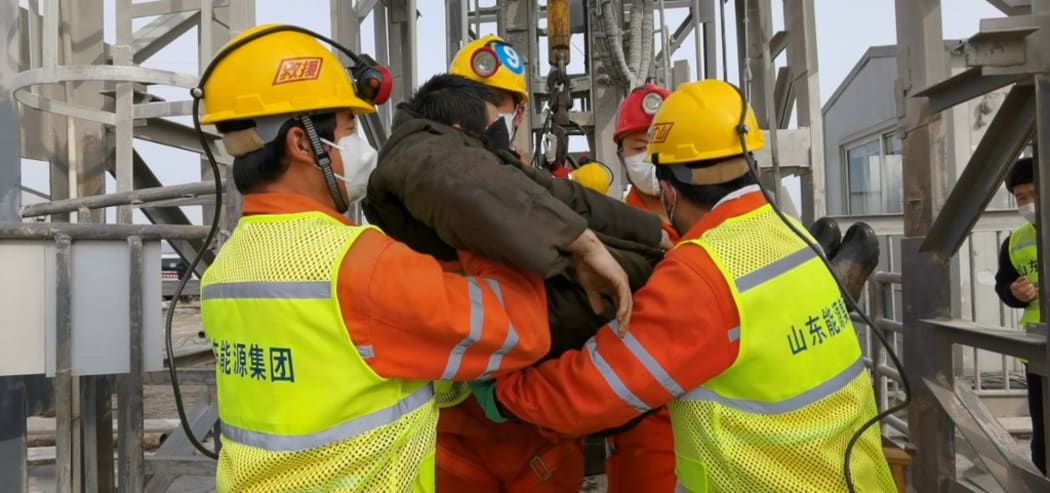 A trapped miner is lifted from a gold mine in Qixia City, east China's Shandong Province.