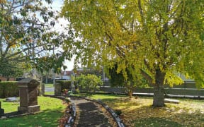St Andrew's Cemetery. Empty spaces where plaques have been removed can be seen.