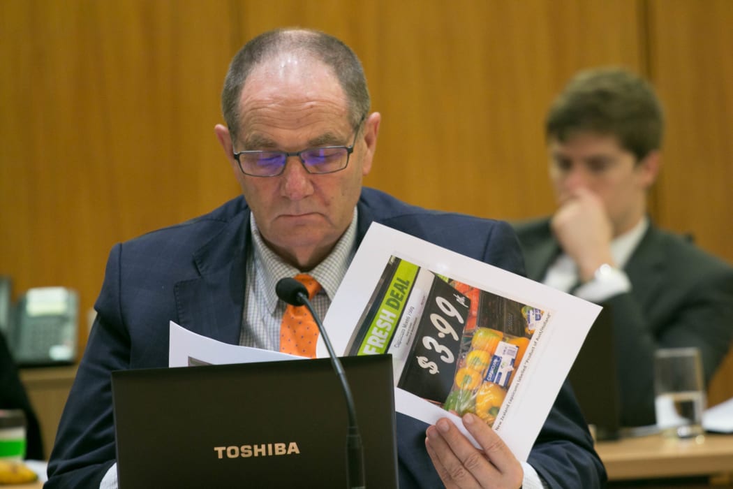 National MP Chester Borrows looks at photos of supermarket signs which incorrectly label the origin of produce.