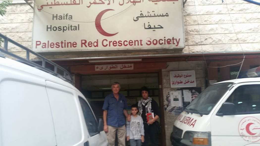 Warren Marriner (right) at Haifa Palestinian camp clinic.