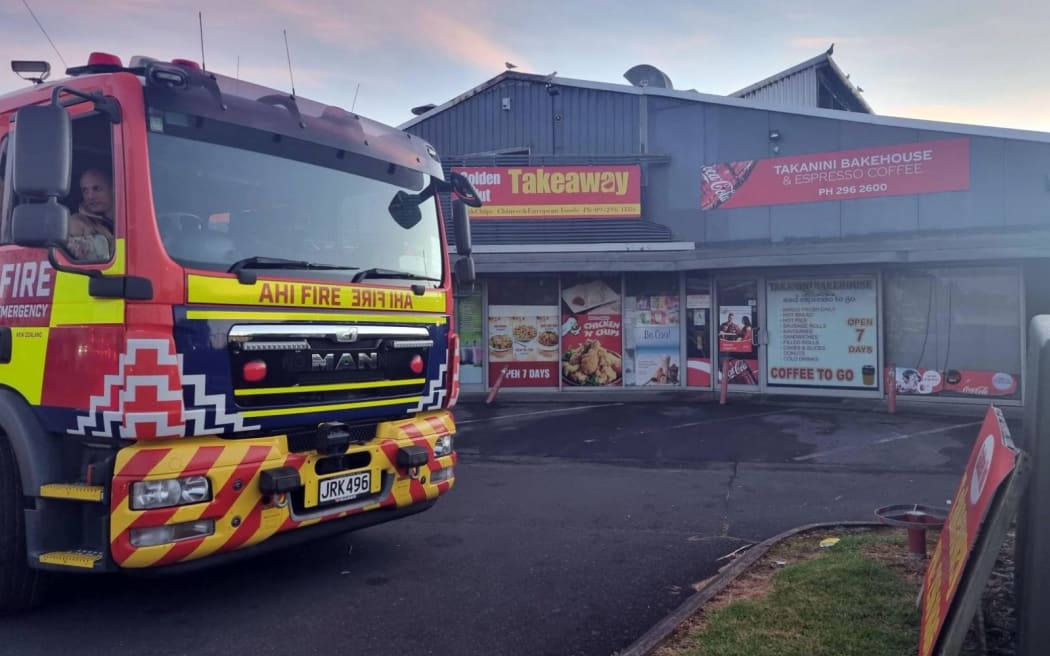A fire truck outside burned-out businesses on Great South Road in Takanini.