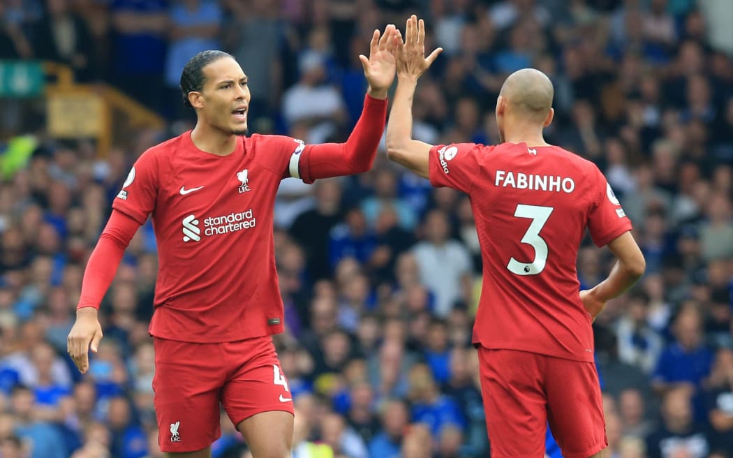 Virgil van Dijk of Liverpool high fives team mate Fabinho