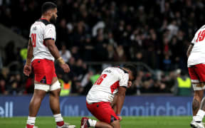 Tonga's Siua Maile (c) is dejected after the game against England.