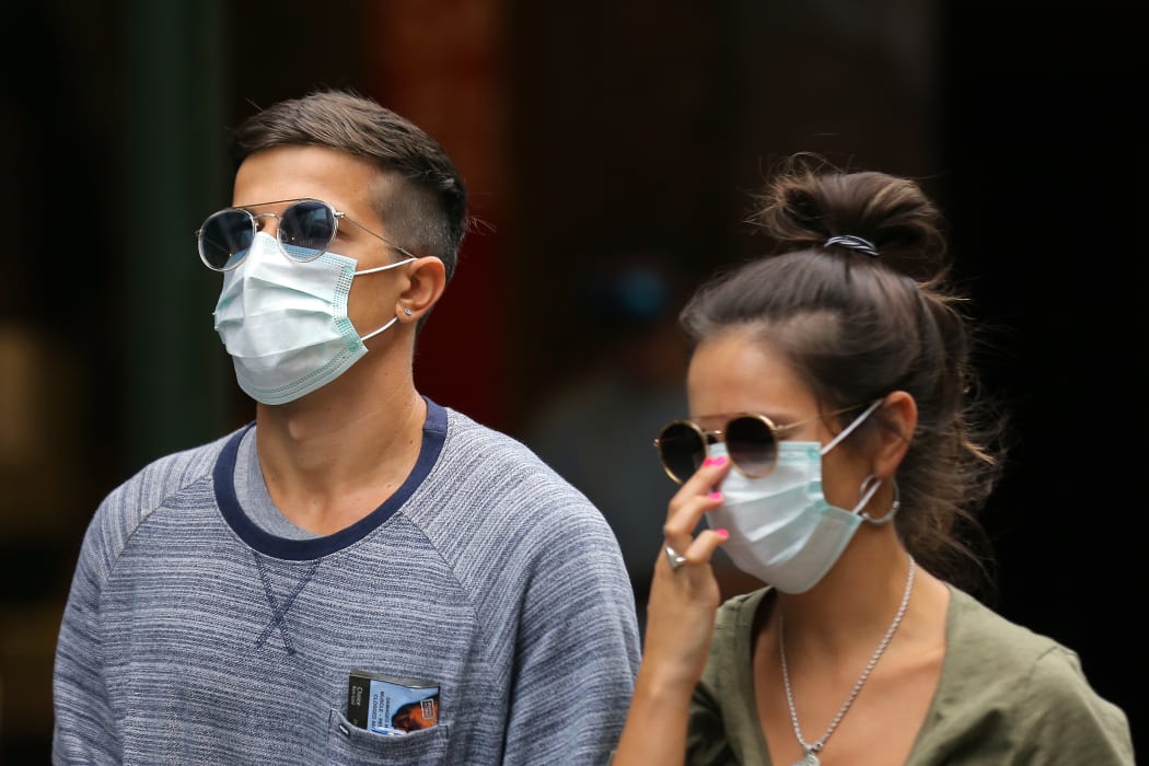 People wearing masks in Sydney, Australia, on March 28, 2020.