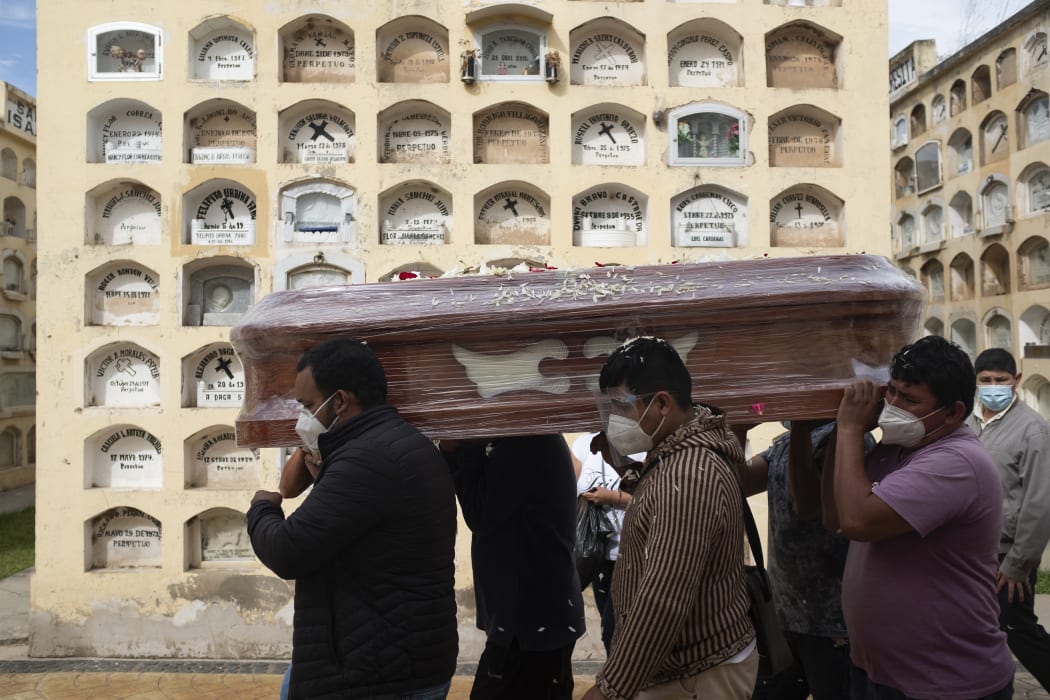Relatives of a Covid-19 victim carry a coffin at the General Cemetery in the central city of Huanuco, 375km northeast of Lima.