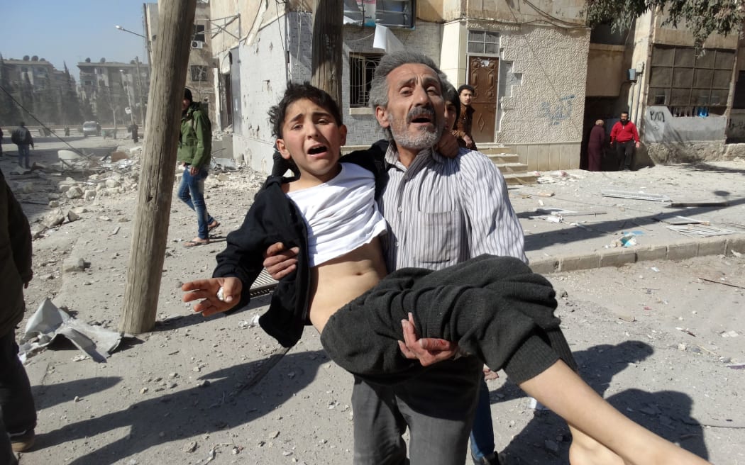 Residents flee an air strike on the outskirts of the northern city of Aleppo.