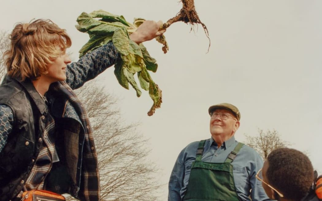 English vegetable gardener Gerald Stratford with two models in a Gucci campaign