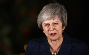 Britain's Prime Minister Theresa May makes a statement outside 10 Downing Street in central London after winning a confidence vote on December 12, 2018. (Photo by Oli SCARFF / AFP)