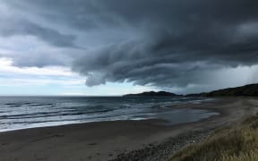 Storm clouds over Tuahine point at Wainui Beach near Gisborne.
