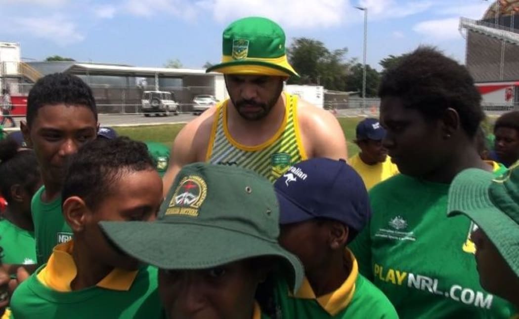 Australian star Greg Inglis talks to local kids in PNG