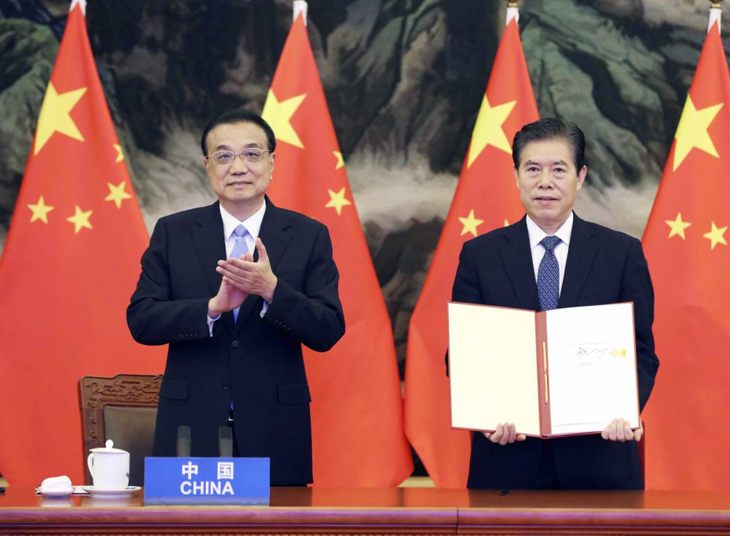 Chinese Premier Li Keqiang attends the signing ceremony of the RCEP agreement along with Commerce Minister Zhong Shan, who signed on behalf of China.