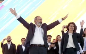 Armenia's acting prime minister, Nikol Pashinyan, waves on stage during a campaign rally in central Yerevan, on June 17, 2021.