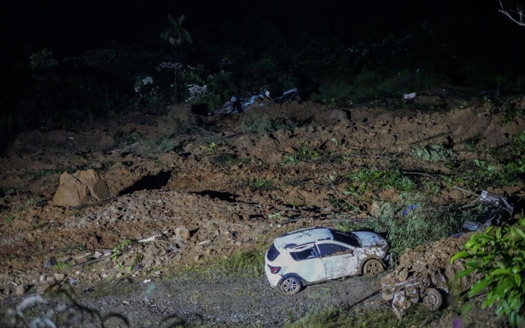 Handout picture released by the Government of Choco press office showing the area of a landslide in the road between Quibdo and Medellin, Choco Department, Colombia, on January 12, 2024. At least 18 people were killed Friday, and around 30 are trapped after a landslide in an indigenous community in northwestern Colombia, an official from the Choco department governor's office told AFP. According to the official, several landslides closed the road leading from the city of Medellin to Quibdo. (Photo by Handout / GOBERNACION DE CHOCO / AFP) / RESTRICTED TO EDITORIAL USE - MANDATORY CREDIT "AFP PHOTO / GOBERNACION DE CHOCO" - NO MARKETING - NO ADVERTISING CAMPAIGNS - DISTRIBUTED AS A SERVICE TO CLIENTS