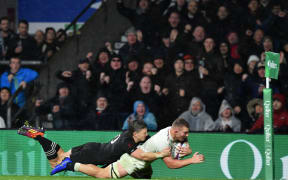 England's flanker Sam Underhill dives over the line as he's tackled by New Zealand's fly-half Beauden Barrett. The try was disallowed.
