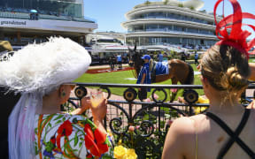 People attend the Melbourne Cup horse race as crowds are allowed to return to the Flemington racecourse in Melbourne on November 2, 2021.