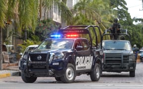 Mexican police and army patrol the streets.