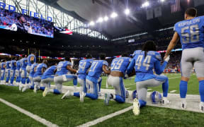 Members of the Detroit Lions take a knee during the playing of the national anthem before the start of a game at Ford Field.