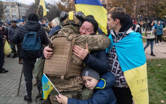 Local residents hug a Ukrainian soldier as they celebrate the liberation of Kherson, on November 14.