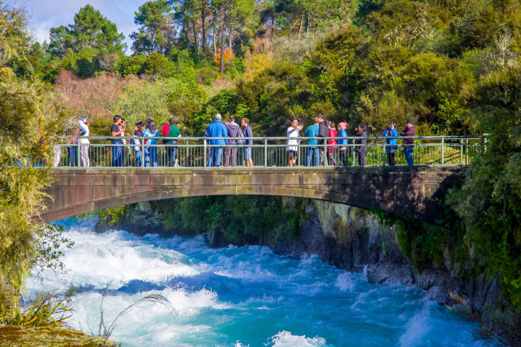 A crowd of people enjoying the view of Huka Falls on the Waikato River near Taupō.