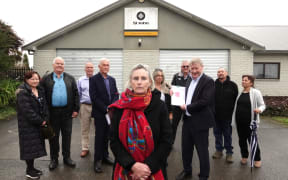 Jo Tucker, centre, with other South Hokianga residents and Northland MP Grant McCallum at Friday's petition handover.