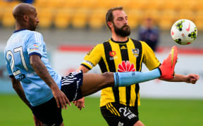 The Phoenix captain Andrew Durante fights for the ball.