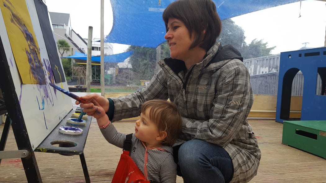 Fiona Roberton helps her daughter Kate (17-months) paint at Newtown Playcentre.