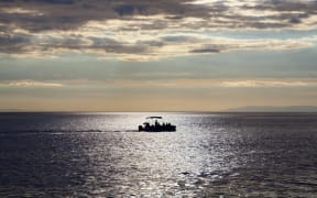 Fishing boat alone in sea.