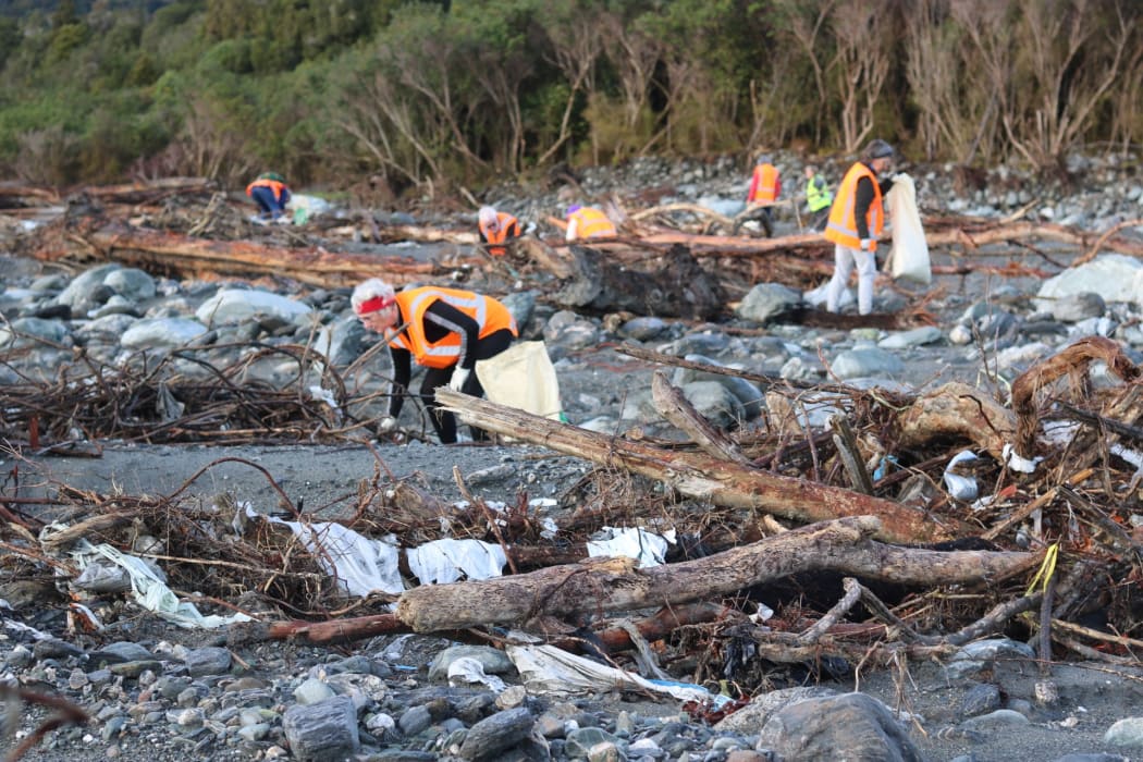 Volunteers pick up rubbish where a disused Fox River landfill spilled litter on the West Coast.