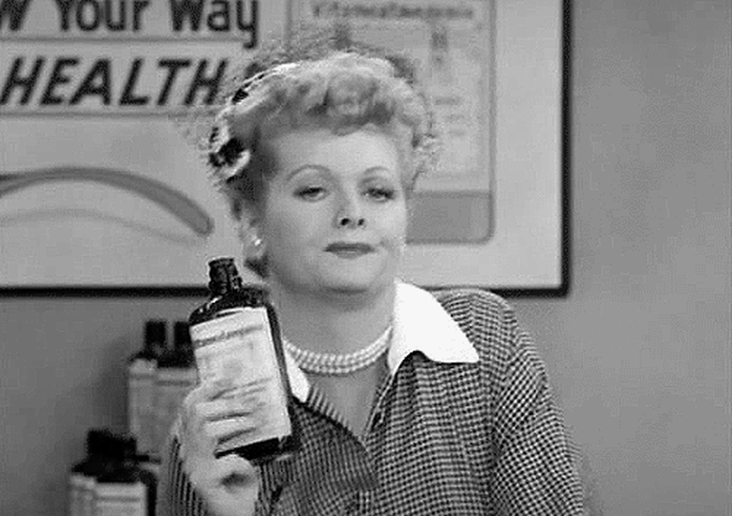 [Actress Lucille Ball drinking from a hip flask and slumping]