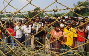 Rohingya Muslims gather behind Myanmar's border lined with barbed wire fences in Maungdaw district, located in Rakhine State bounded by Bangladesh.