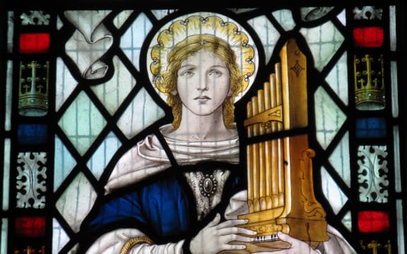 Saint Cecilia in a window in the church of St Mary the Virgin in Little Wymondley in Hertfordshire