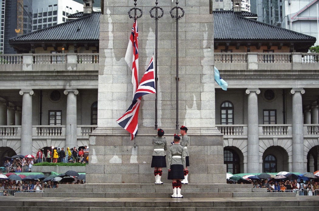Three British soldiers lower the Union Jack for the last time at the Cenotaph monument in the Central district of Hong Kong on 30 June 1997, just hours prior to the end of some 156 years of British colonial rule as the territory returned to Chinese control.